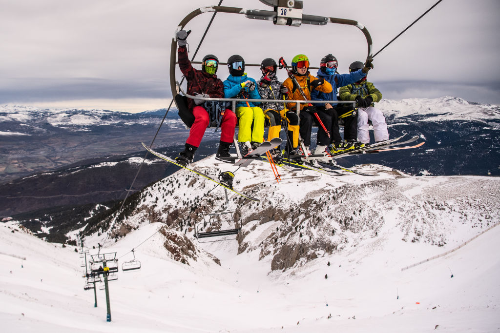 Skiers ride a chairlift at La Masella ski resort on December 14, 2020 in Girona